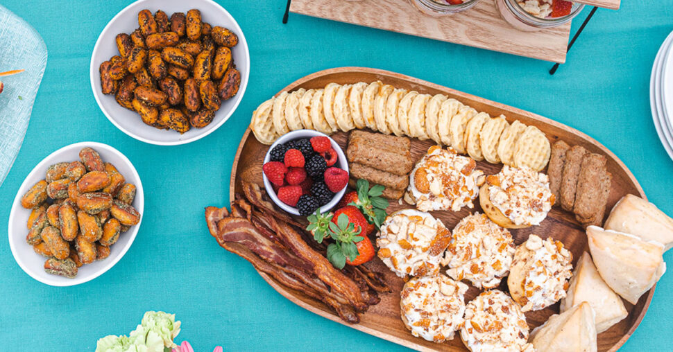 A table set with various plates filled with an assortment of delicious food items.