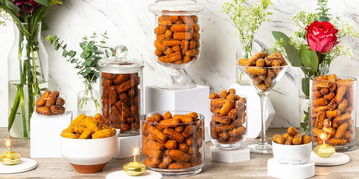 A table displaying various types of food stored in glass jars, showcasing colorful ingredients and diverse culinary options.