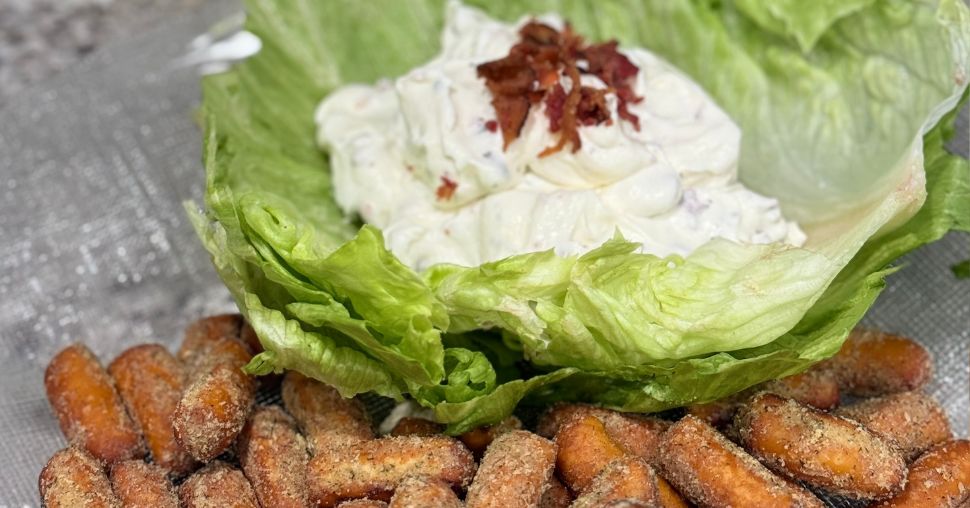 White BLT dip on a bed of lettuce with bacon bits on top and OMG! Garlic Pretzels on the side