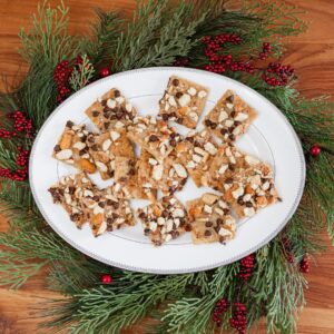 Pretzel Heath Cookies organized on a white oval plate and placed on a festive wreath