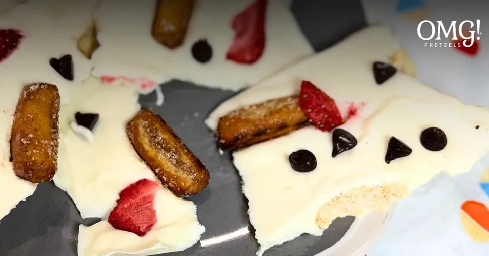 White chocolate banana bread crackers arranged on a wooden surface, showcasing their golden-brown color and texture.