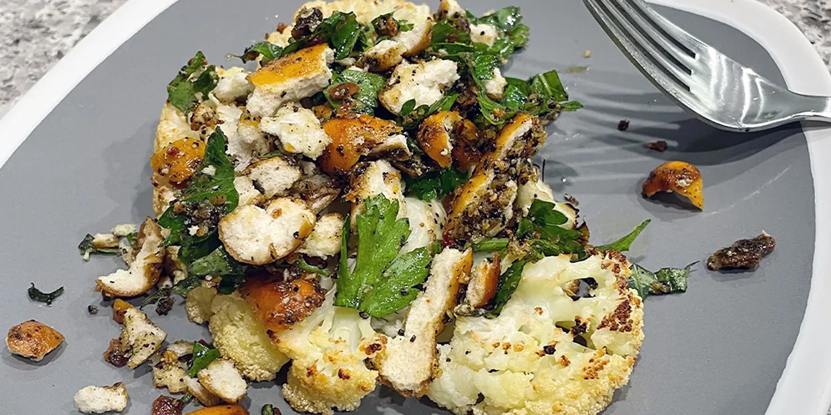 A plate filled with a colorful assortment of food items, including vegetables, grains, and protein.