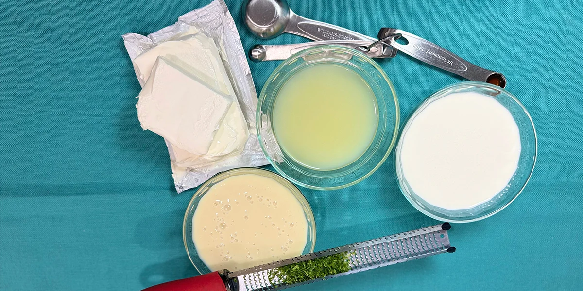 A collection of ingredients for yogurt-making, including milk, yogurt starter, and optional flavorings like fruit and honey.